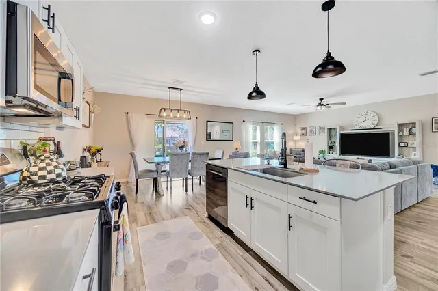 a kitchen with stainless steel appliances a stove sink and cabinets