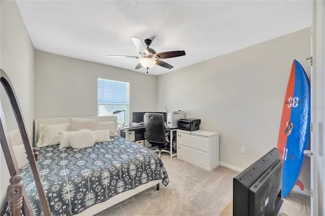 a bedroom with a bed and a couch