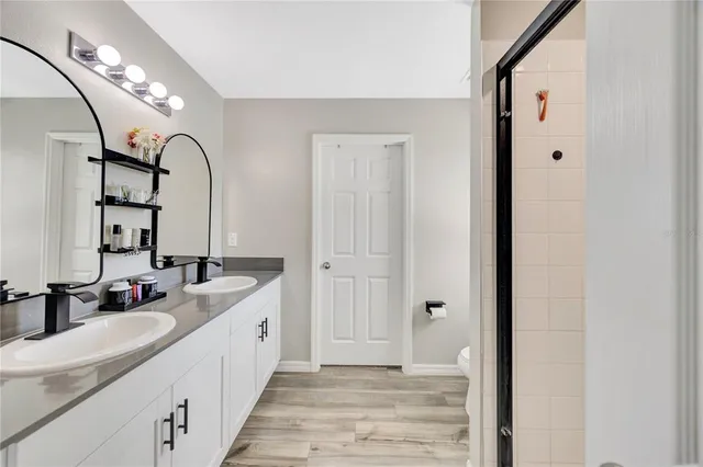 a spacious bathroom with a double vanity sink and a mirror