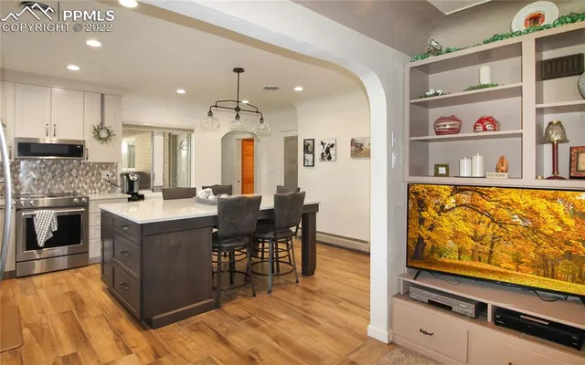 a kitchen with stainless steel appliances granite countertop a stove and a refrigerator