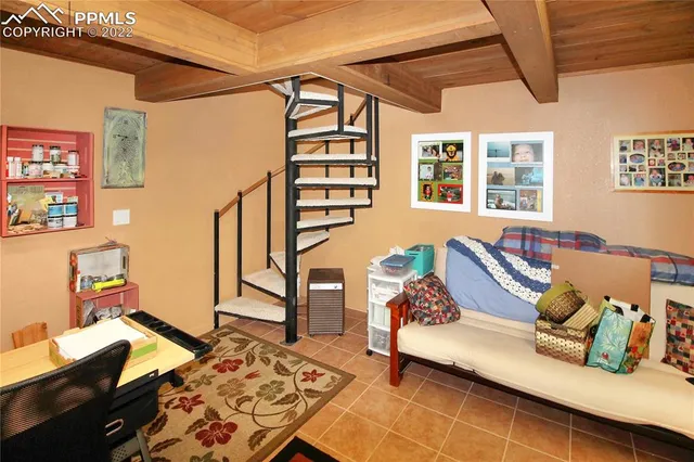 a kitchen with stainless steel appliances granite countertop a dining table chairs refrigerator and wooden floor