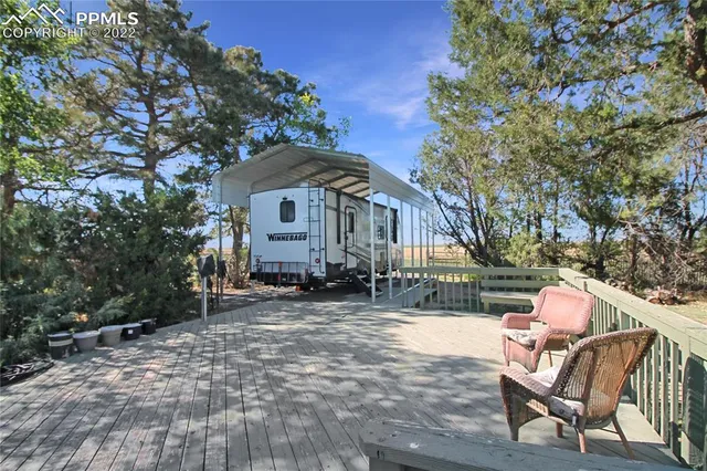 a front view of a house with table and chairs