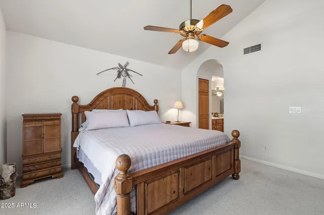 a bedroom with a bed and a large window