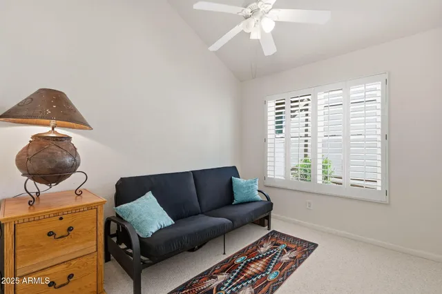 a patio with a table and chairs under an umbrella