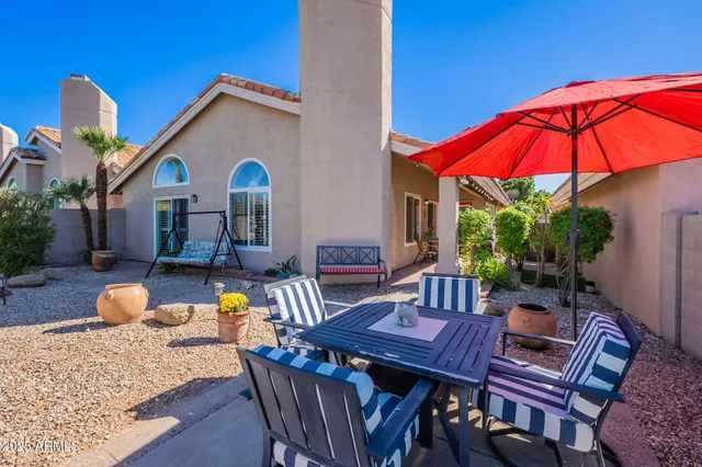 a view of a grassy field with mountains in the background