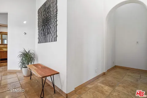 a bedroom with a bed and a potted plant