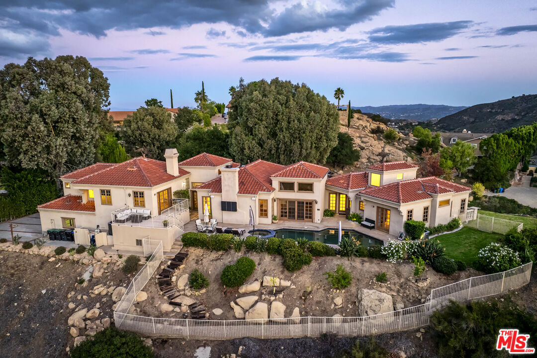 19 Ranchero Road Bell Canyon, CA 91307 - Photo 46 of 46 a front view of a house with a yard and outdoor seating