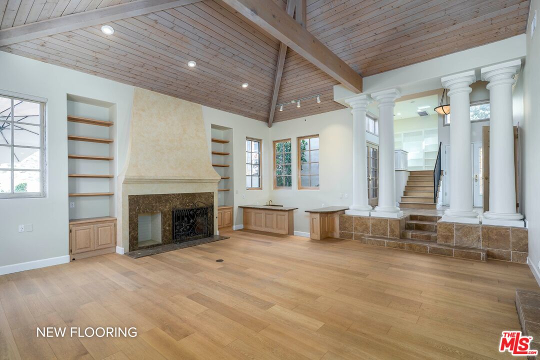 19 Ranchero Road Bell Canyon, CA 91307 - Photo 7 of 46 a view of an empty room with a fireplace and a window