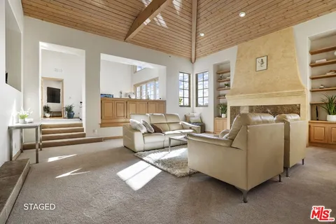 a kitchen with a granite countertop sink a stove and a window