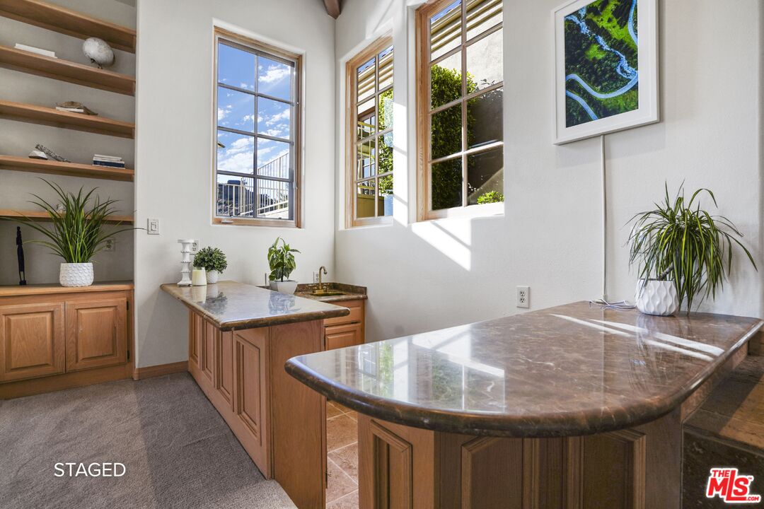 19 Ranchero Road Bell Canyon, CA 91307 - Photo 9 of 46 a kitchen with a granite countertop sink a stove and a window