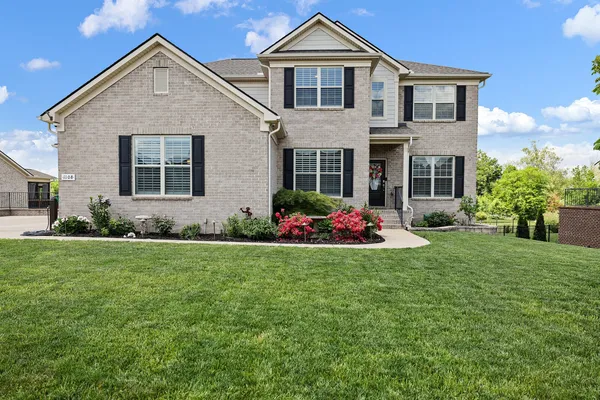 a front view of a house with a yard and garage