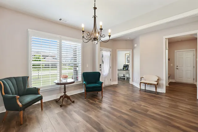 a kitchen with stainless steel appliances kitchen island granite countertop a stove a sink a refrigerator and a microwave