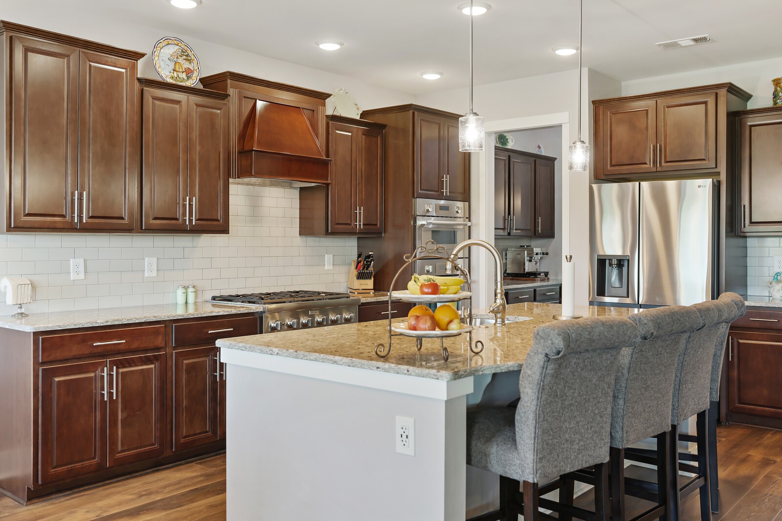 1108 Brixworth Drive Spring Hill, TN 37174 - Photo 20 of 100 a kitchen with stainless steel appliances granite countertop a refrigerator a stove and a sink with wooden cabinets