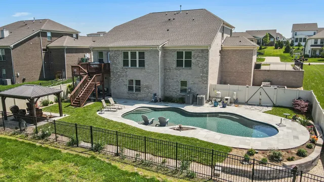 a view of a house with swimming pool and sitting area