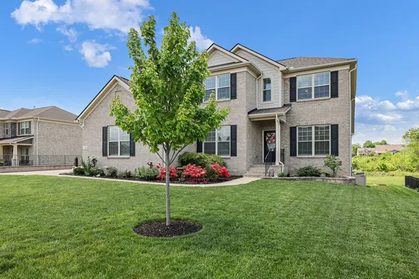 a front view of a house with a garden