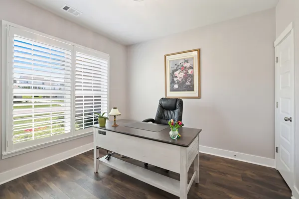 a kitchen with stainless steel appliances granite countertop a sink dishwasher stove and cabinets with wooden floor