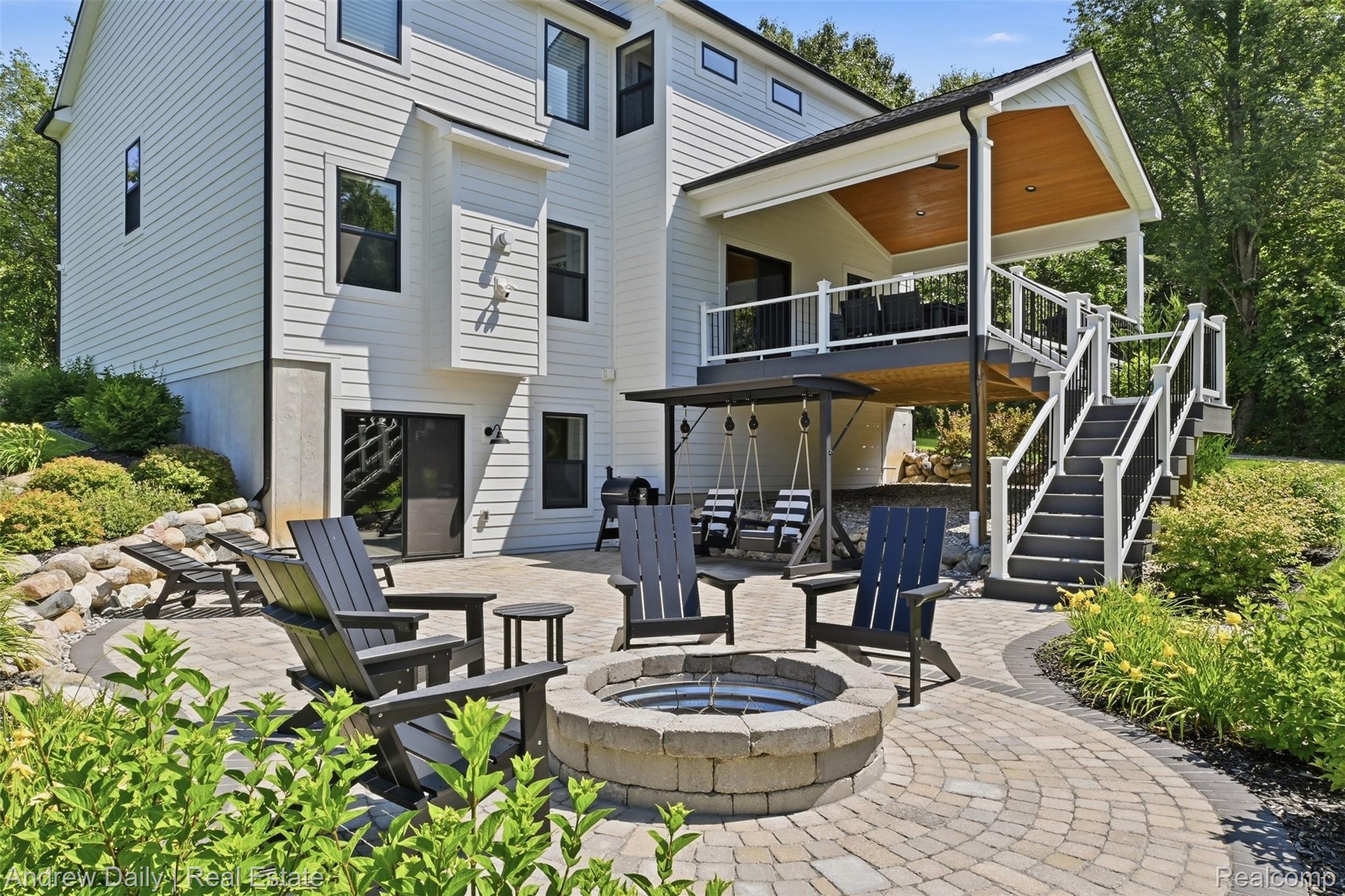 4661 Spears Road Pinckney, MI 48169 - Photo 48 of 56 Expansive paver patio featuring a stone-ringed fire pit and a tiered landscaping design