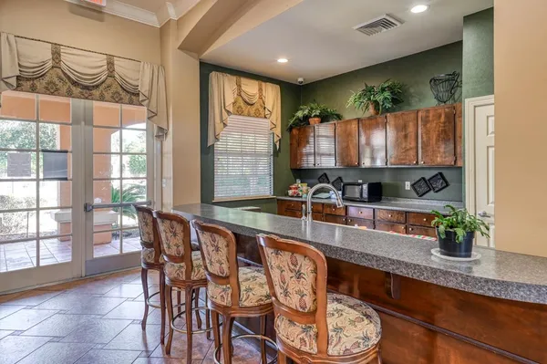 a large kitchen with a table and chairs in it