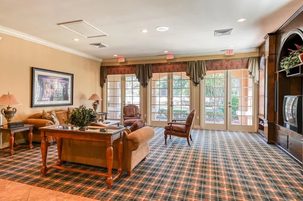 a living room with furniture rug and a flat screen tv