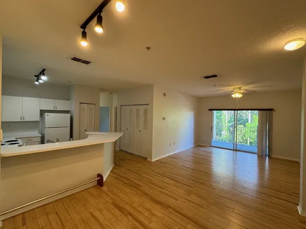 a view of a kitchen with a sink and a large window