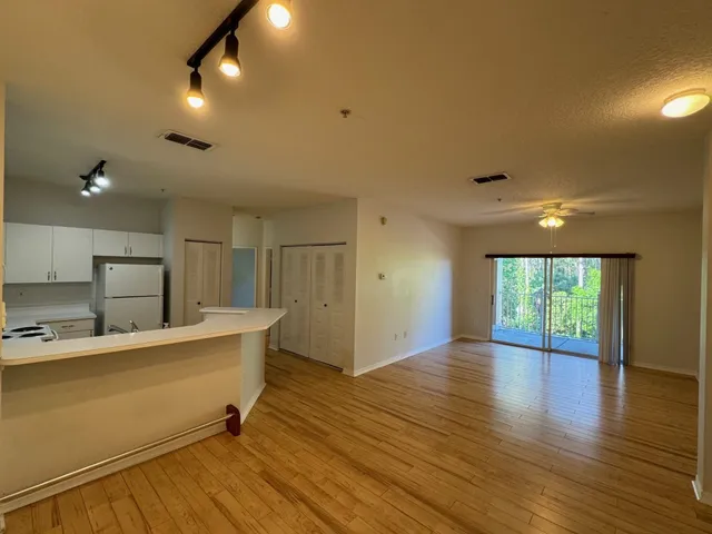 a view of a kitchen with a sink and a large window
