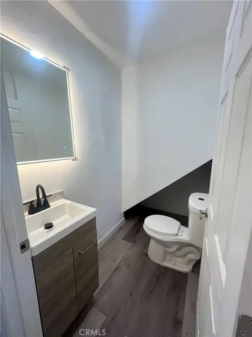 a bathroom with a sink a toilet and mirror