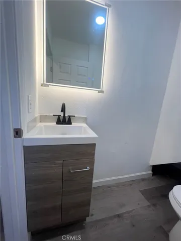 a bathroom with a sink a vanity and a toilet