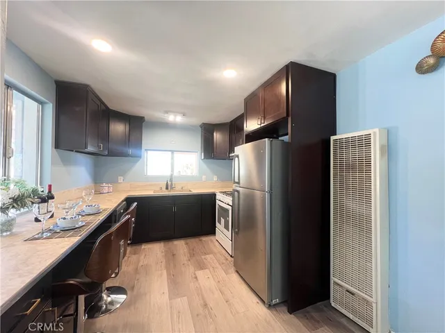a kitchen with a refrigerator and a sink