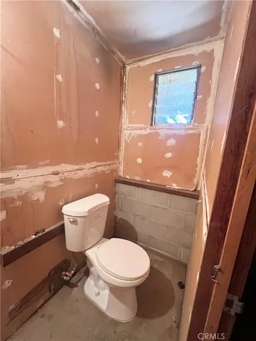 a white toilet sitting next to a bathroom sink