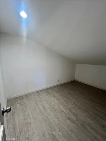 a view of an empty room and wooden floor