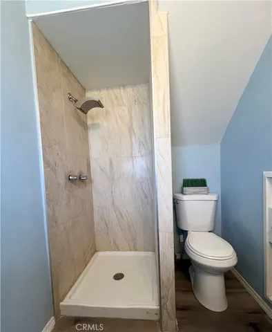 a bathroom with a toilet and a shower