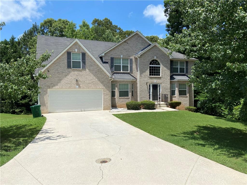 3611 Thistle Oak Trace Decatur, GA 30034 - Photo 1 of 1 a front view of a house with a yard and garage
