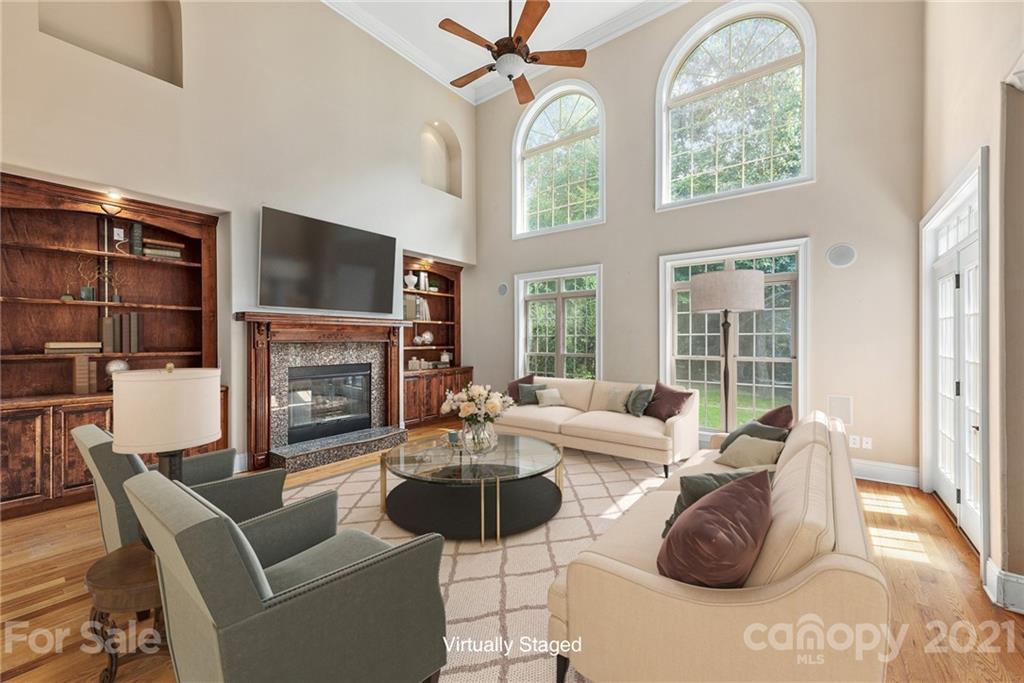 a living room with fireplace furniture and a flat screen tv