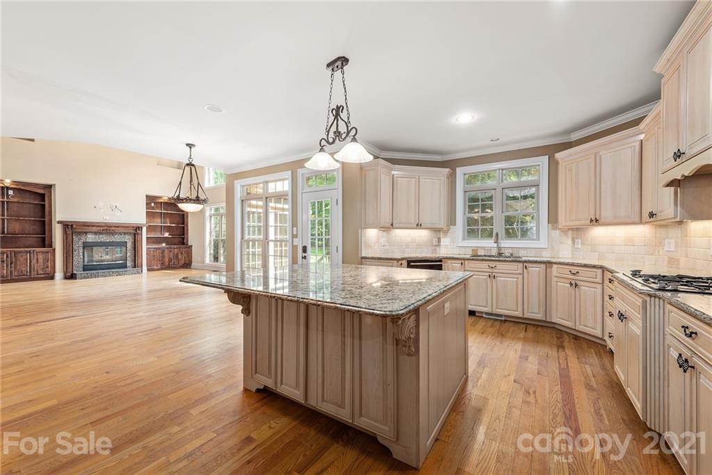 3268 Millstone Creek Road Lancaster, SC 29720 - Photo 28 of 35 a kitchen with stainless steel appliances granite countertop a sink stove and wooden floor