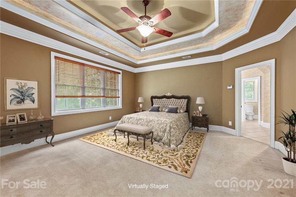 3268 Millstone Creek Road Lancaster, SC 29720 - Photo 4 of 35 a bedroom with a large bed and a chandelier