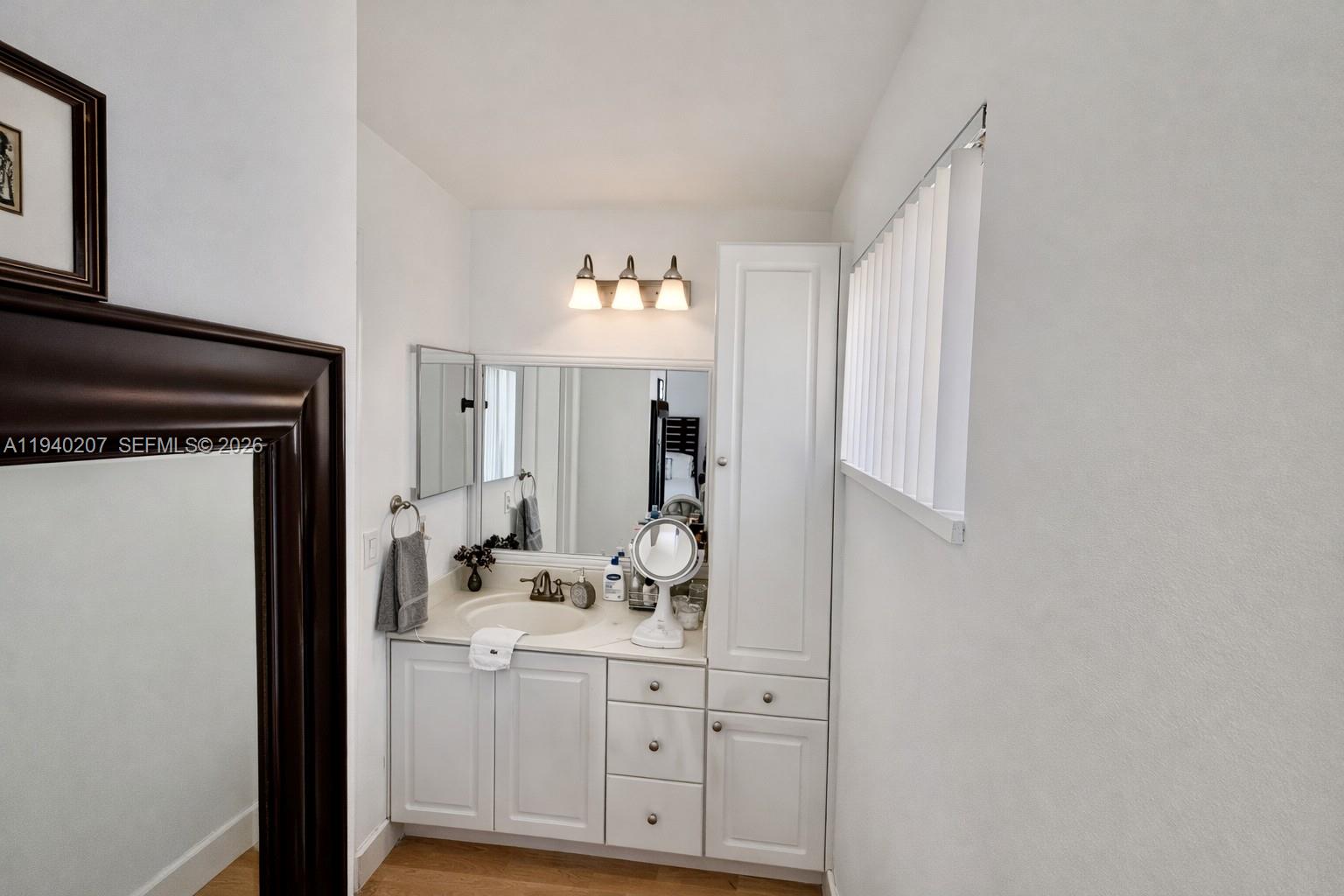 20125 Southwest 124th Avenue Miami, FL 33177 - Photo 11 of 21 a bathroom with a sink a mirror and a vanity