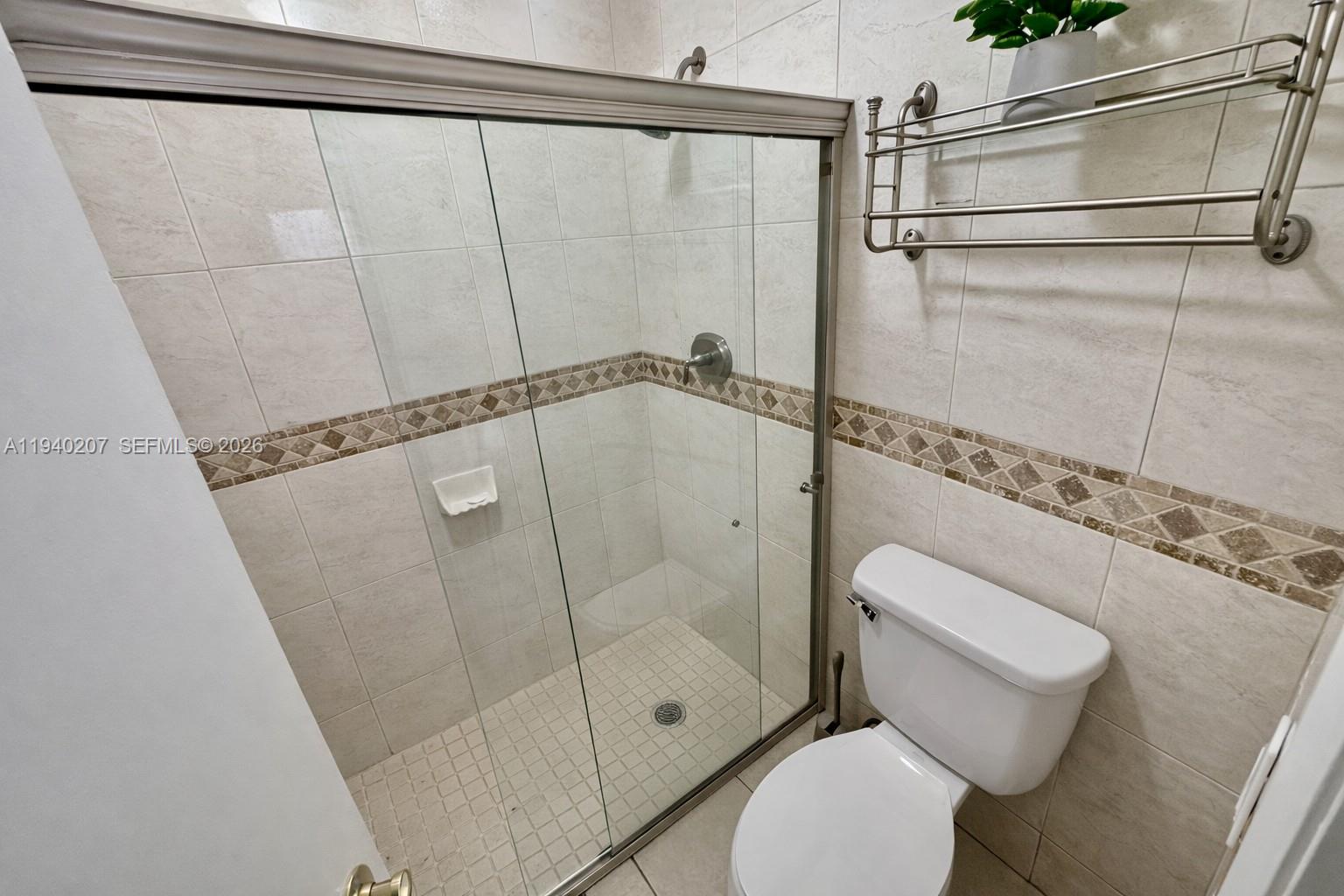 20125 Southwest 124th Avenue Miami, FL 33177 - Photo 12 of 21 a bathroom with a toilet and a shower