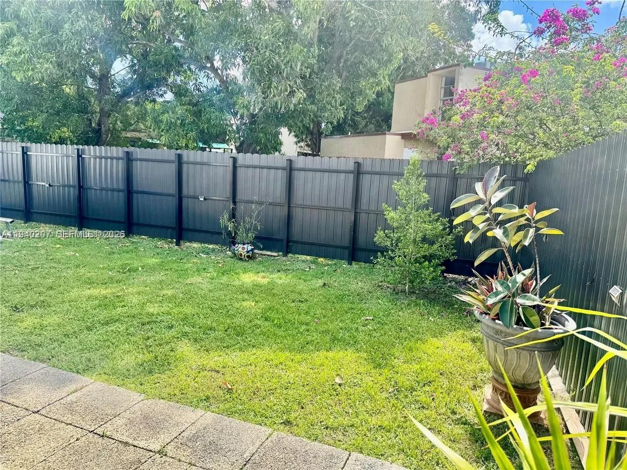 20125 Southwest 124th Avenue Miami, FL 33177 - Photo 20 of 21 a backyard of a house with lots of green space and plants