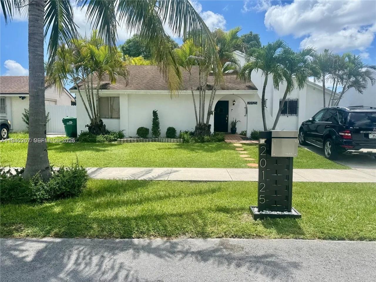 20125 Southwest 124th Avenue Miami, FL 33177 - Photo 21 of 21 a front view of a house with garden and trees