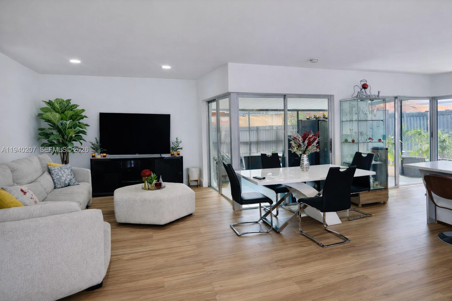 20125 Southwest 124th Avenue Miami, FL 33177 - Photo 3 of 21 a living room with furniture and a flat screen tv