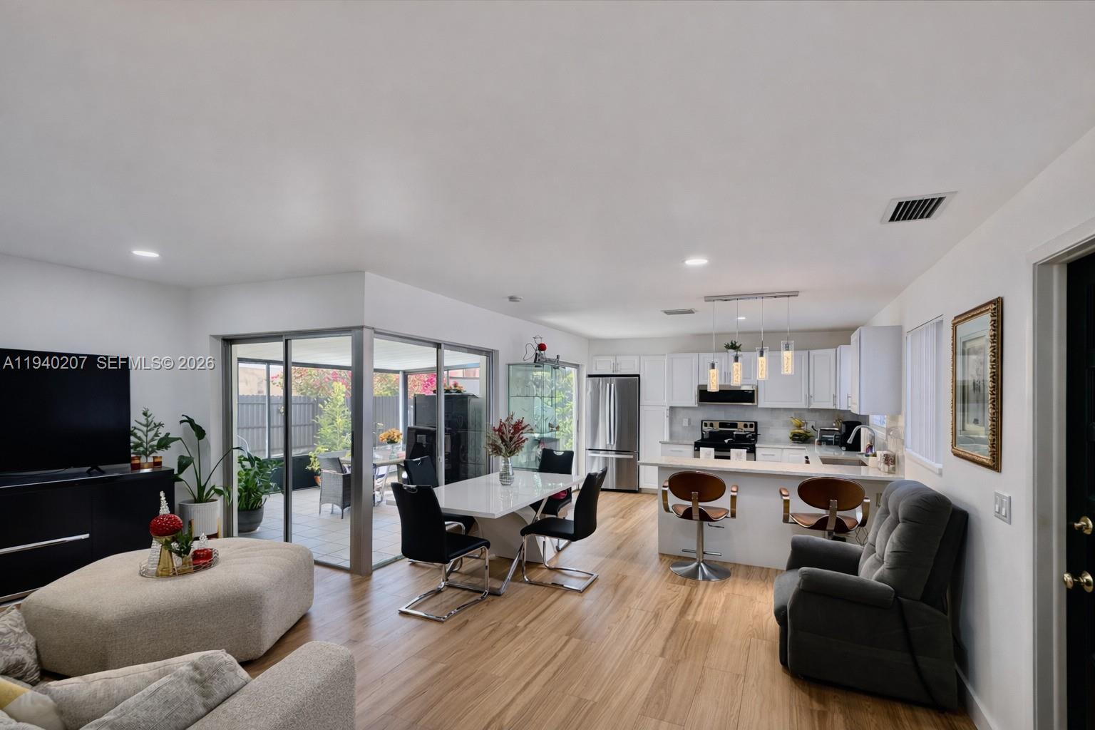 20125 Southwest 124th Avenue Miami, FL 33177 - Photo 4 of 21 a living room with furniture kitchen view and a large window