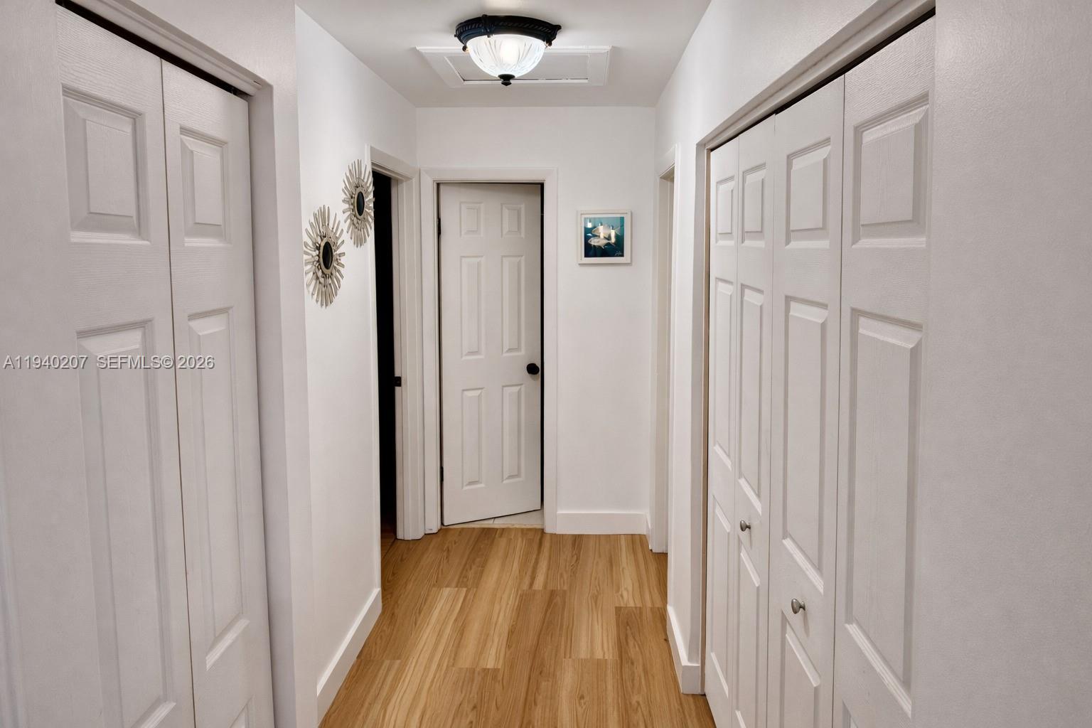 20125 Southwest 124th Avenue Miami, FL 33177 - Photo 5 of 21 a view of a hallway with wooden floor and a bathroom