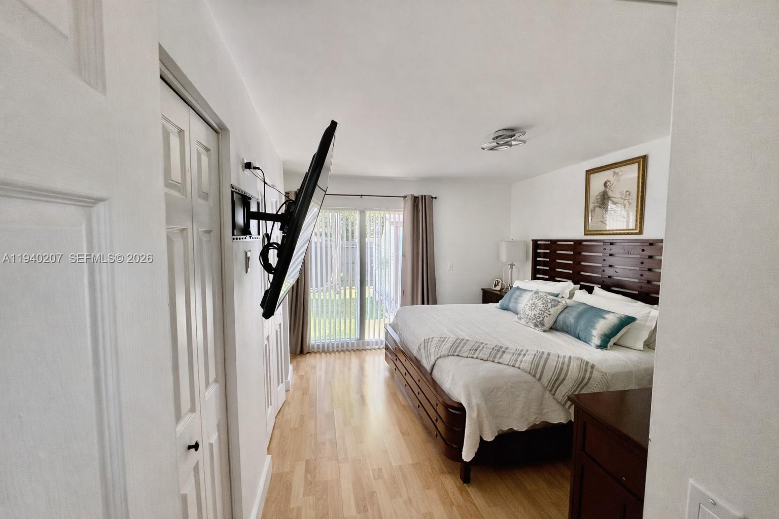 20125 Southwest 124th Avenue Miami, FL 33177 - Photo 9 of 21 a bedroom with a bed and a mirror