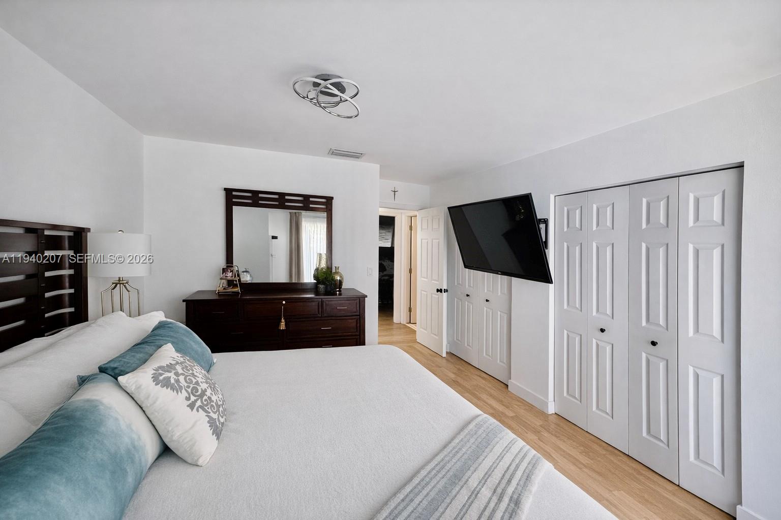 20125 Southwest 124th Avenue Miami, FL 33177 - Photo 10 of 21 a living room with a flat screen tv and a couch