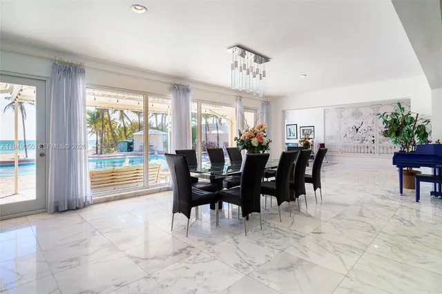 a view of a white house with a large windows and plants