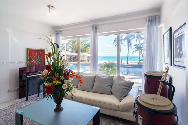 a living room with lots of furniture wooden floor and a table