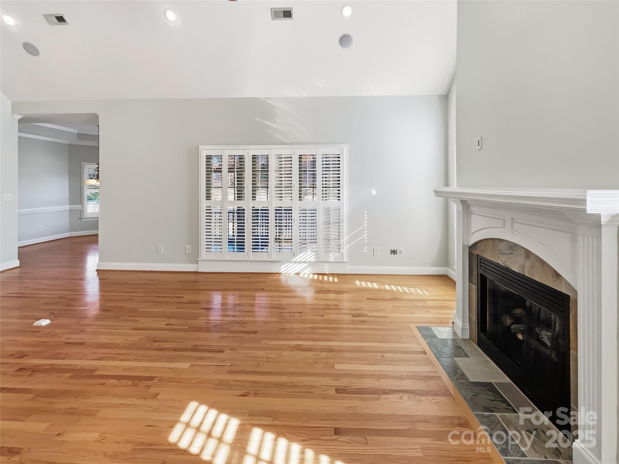 924 Ferguson Ridge Road Gastonia, NC 28052 - Photo 12 of 23 a view of empty room with wooden floor and fireplace