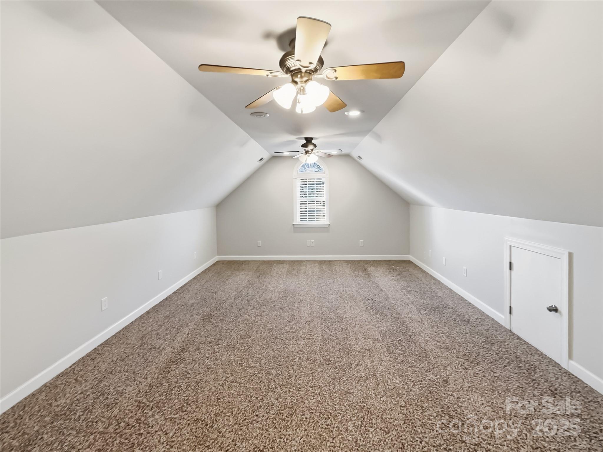 924 Ferguson Ridge Road Gastonia, NC 28052 - Photo 20 of 23 an empty room with a chandelier fan and windows