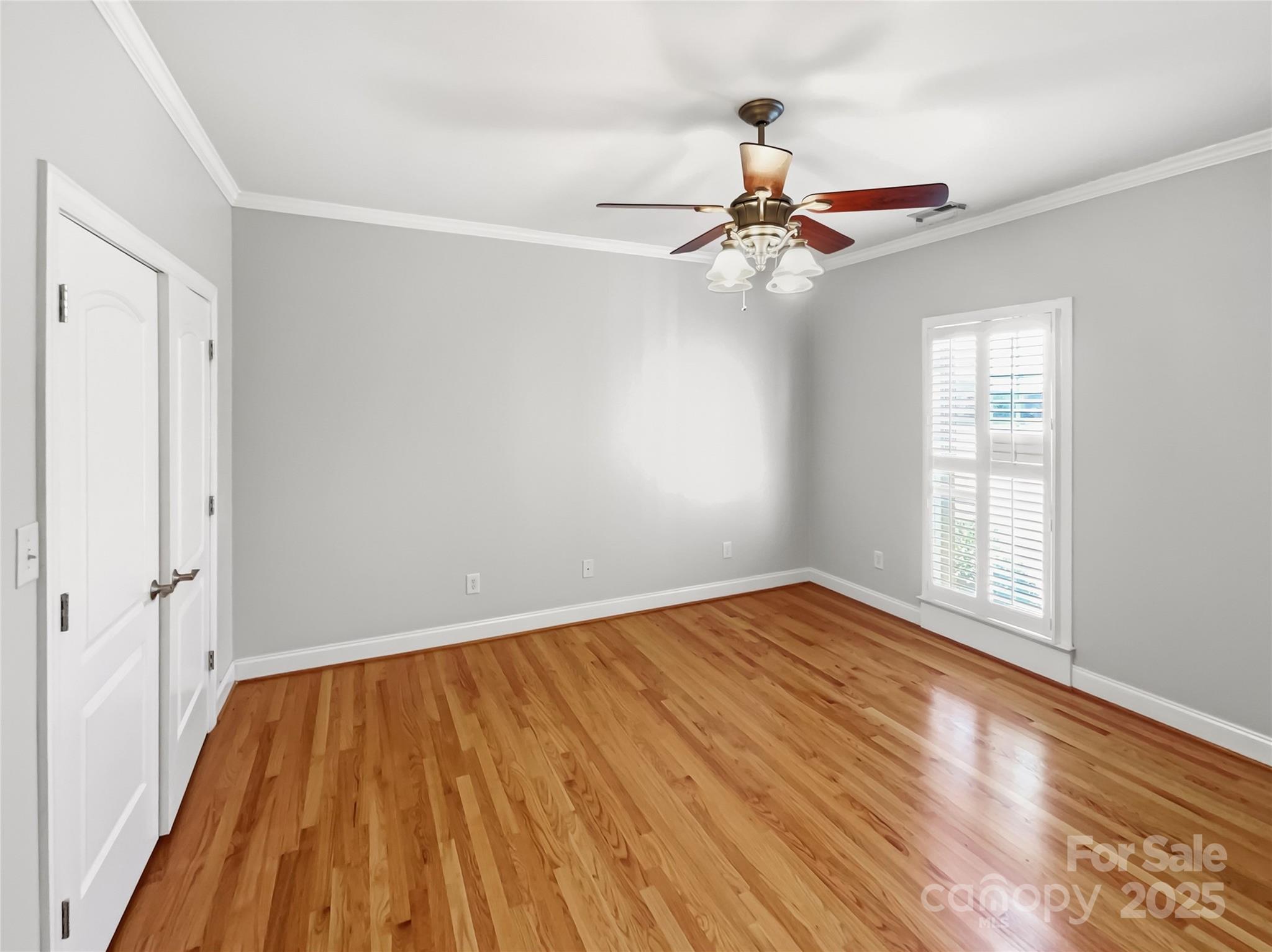 924 Ferguson Ridge Road Gastonia, NC 28052 - Photo 21 of 23 an empty room with wooden floor fan and windows