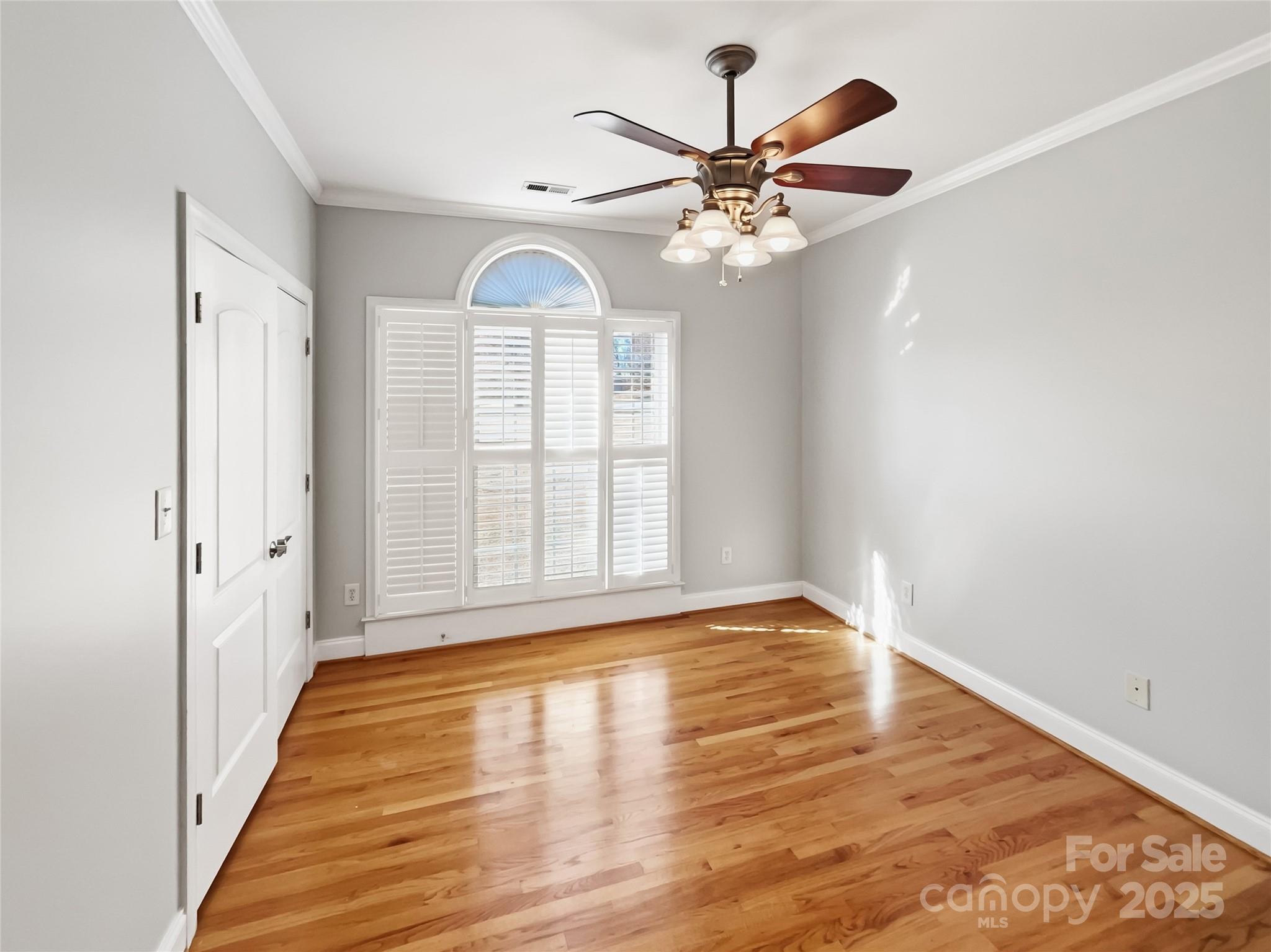 924 Ferguson Ridge Road Gastonia, NC 28052 - Photo 4 of 23 an empty room with wooden floor fan and windows
